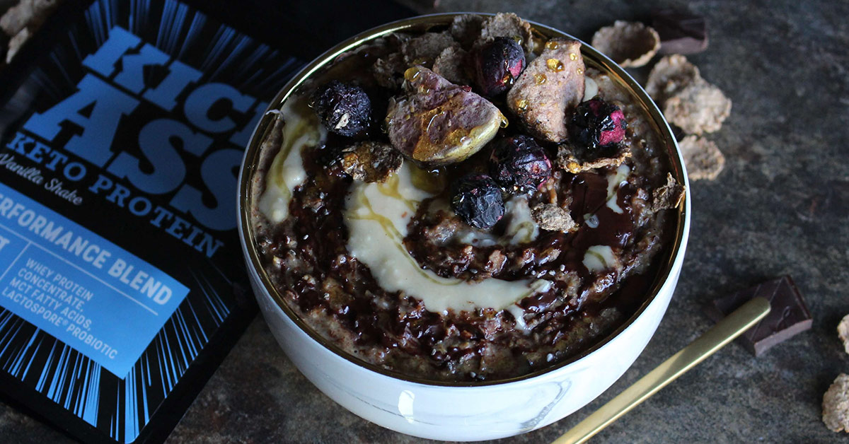Choc Blueberry All Bran Porridge in a bowl with decorative toppings.